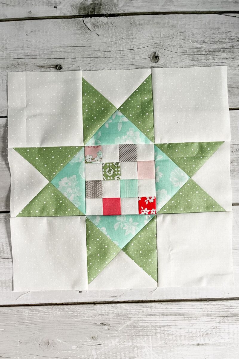 The Summer Quilt block made with a 16 patch center star block offset by hourglass quilt blocks