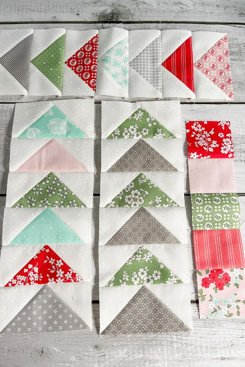 The finishing pieces for the Shine Bright Sampler quilt. Strip of squares blocks and three strips of flying geese units