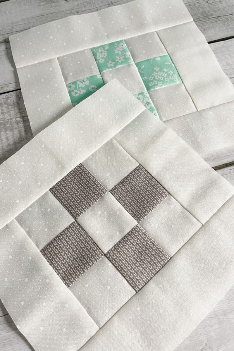 Nine patch quilt blocks in grey and aqua with a white background fabric.
