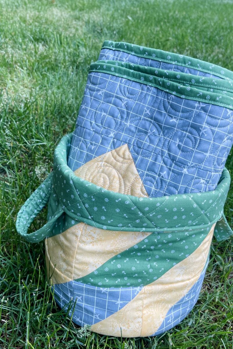 Swoon baby quilt rolled up to gift in the medium sized Olivia's Basket pattern.