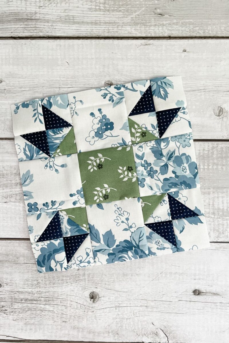 9 inch Tulip Lady Finger quilt block made with the blue and green fabrics from the Dwell fabric collection