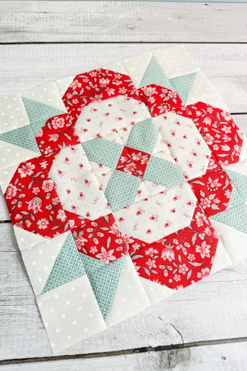 Happiness Blooms quilt block in red, pink, and teal fabrics from the My Summer House fabric collection