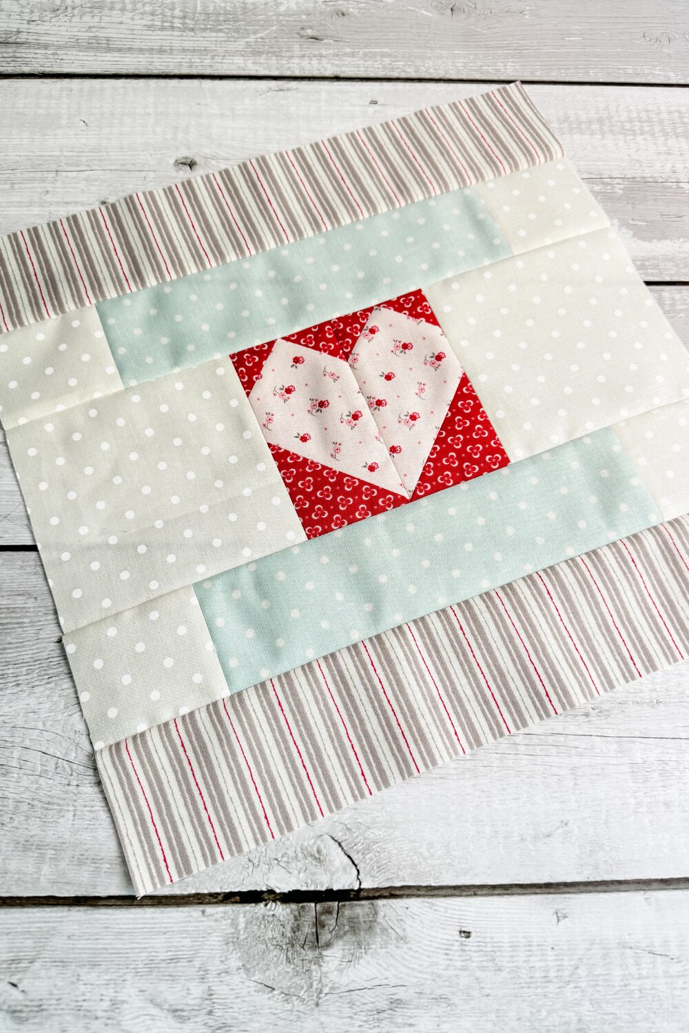 2024 Designer Mystery Month 1 quilt block is a courthouse steps variation