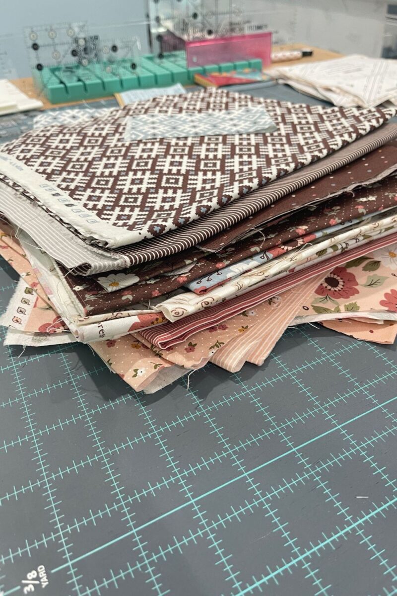 Stack of scrap fabrics leftover from a Folktale fat quarter bundle