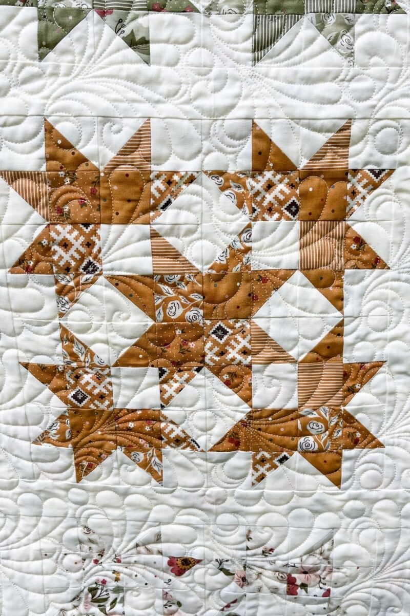 Gold fabric star blocks made with squares and half square triangle units.