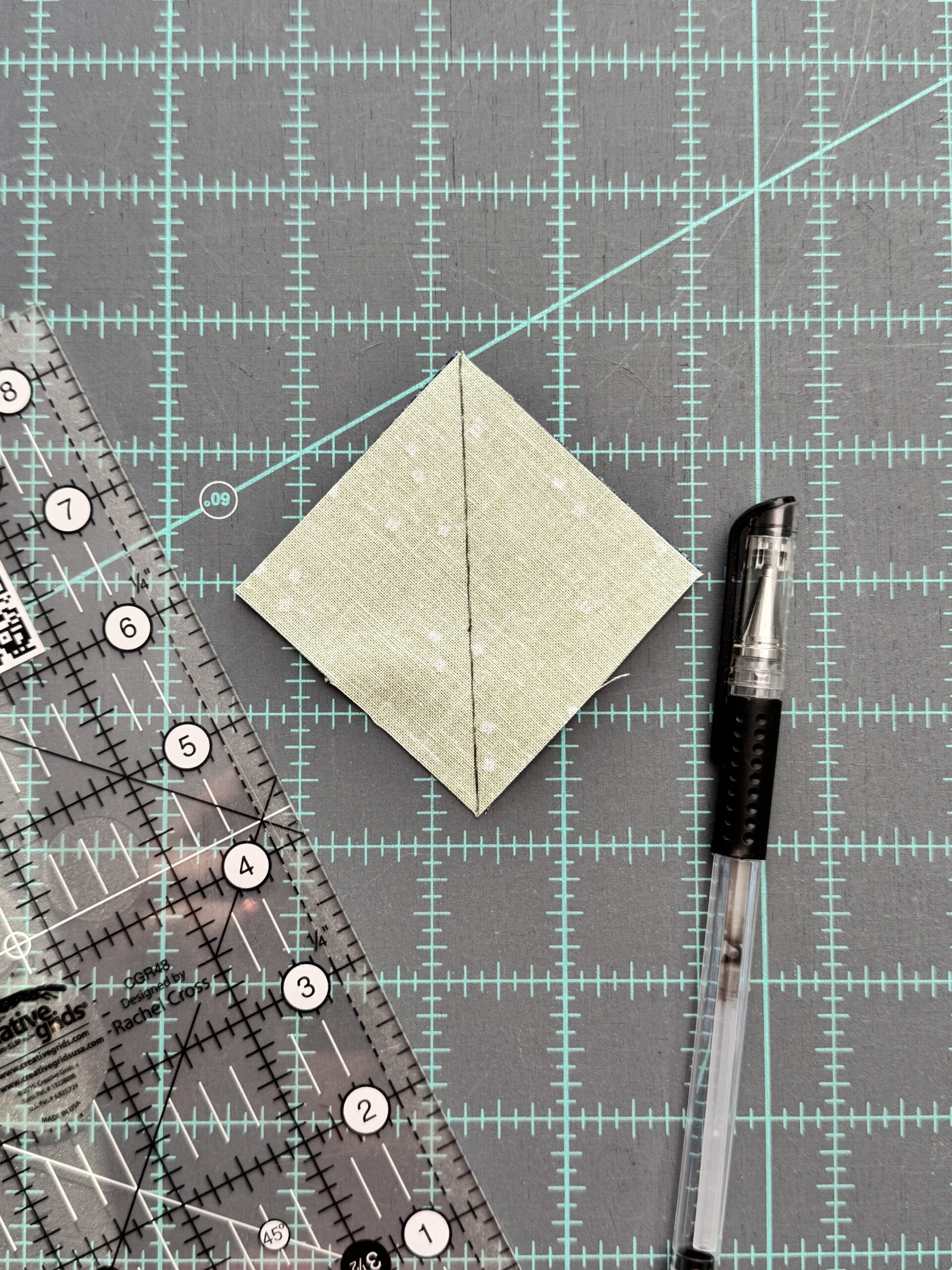 diagonal line drawn on fabric squares for one at a time half square triangle