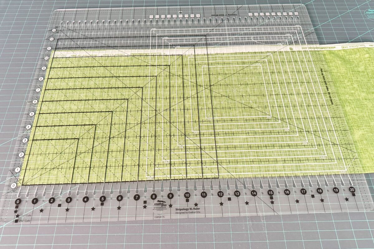 Using the Stripology Quilt Ruler to cut multiple layers of fabric precisely.