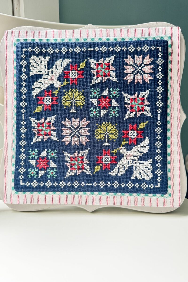 Finished Moonbeams cross stitch mounted on a grey Primrose board