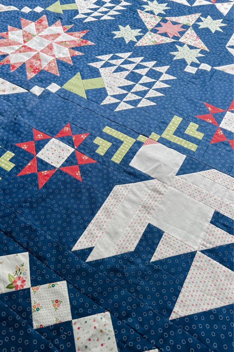 Corner view of the quilt blocks in the Moonbeams quilt along with Fat Quarter Shop