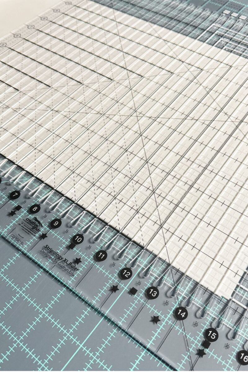 Close-up of a Stripology ruler cutting multiple fabric strips