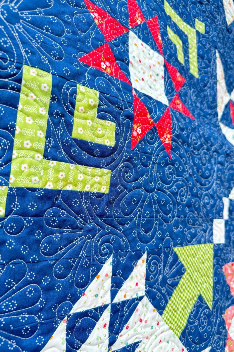 Close-up of the Moonbeams Quilt showcasing detailed quilting for a cheerful finished quilt.