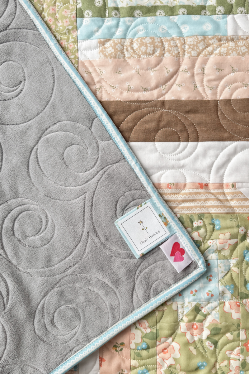 A close-up of the grey Shannon Cuddle fabric backing on a quilt.