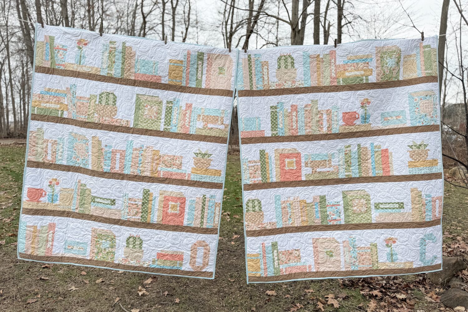 Two quilts side-by-side with bookshelf designs, personalized for Camryn and Olivia.