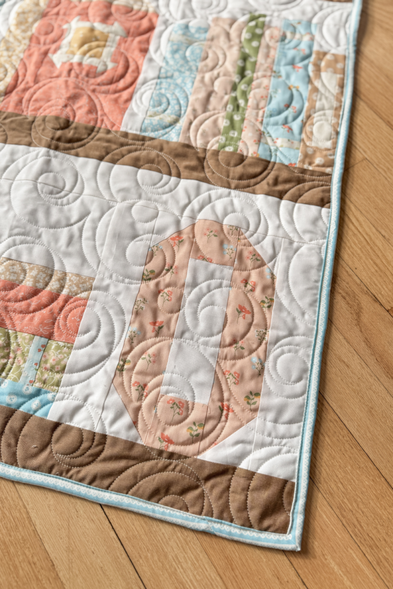 Personalized "O" quilt block in Olivia’s bookshelf quilt.