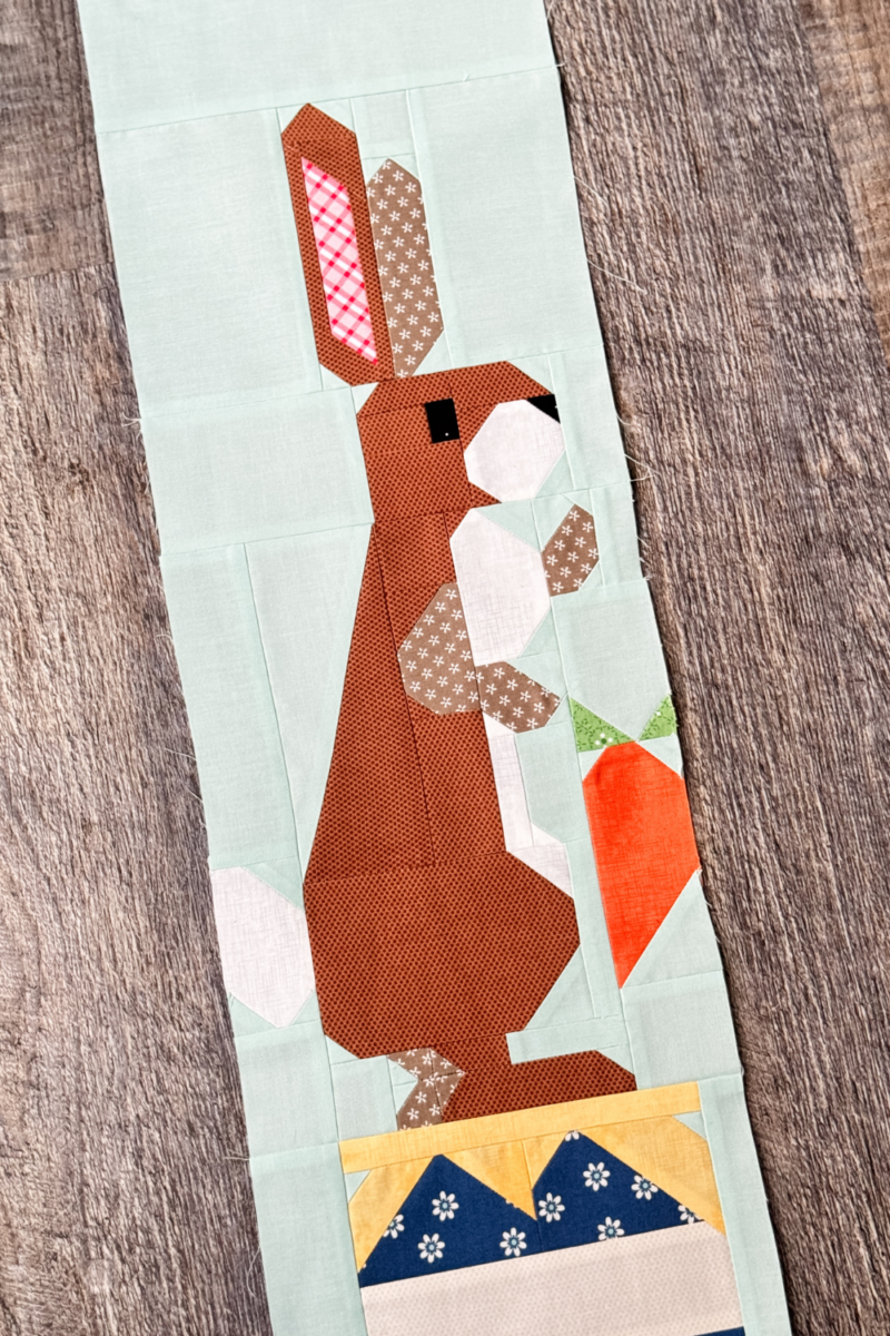 Close-up of Rabbit quilt block highlighting Rabbit’s face and the carrot in his hand.