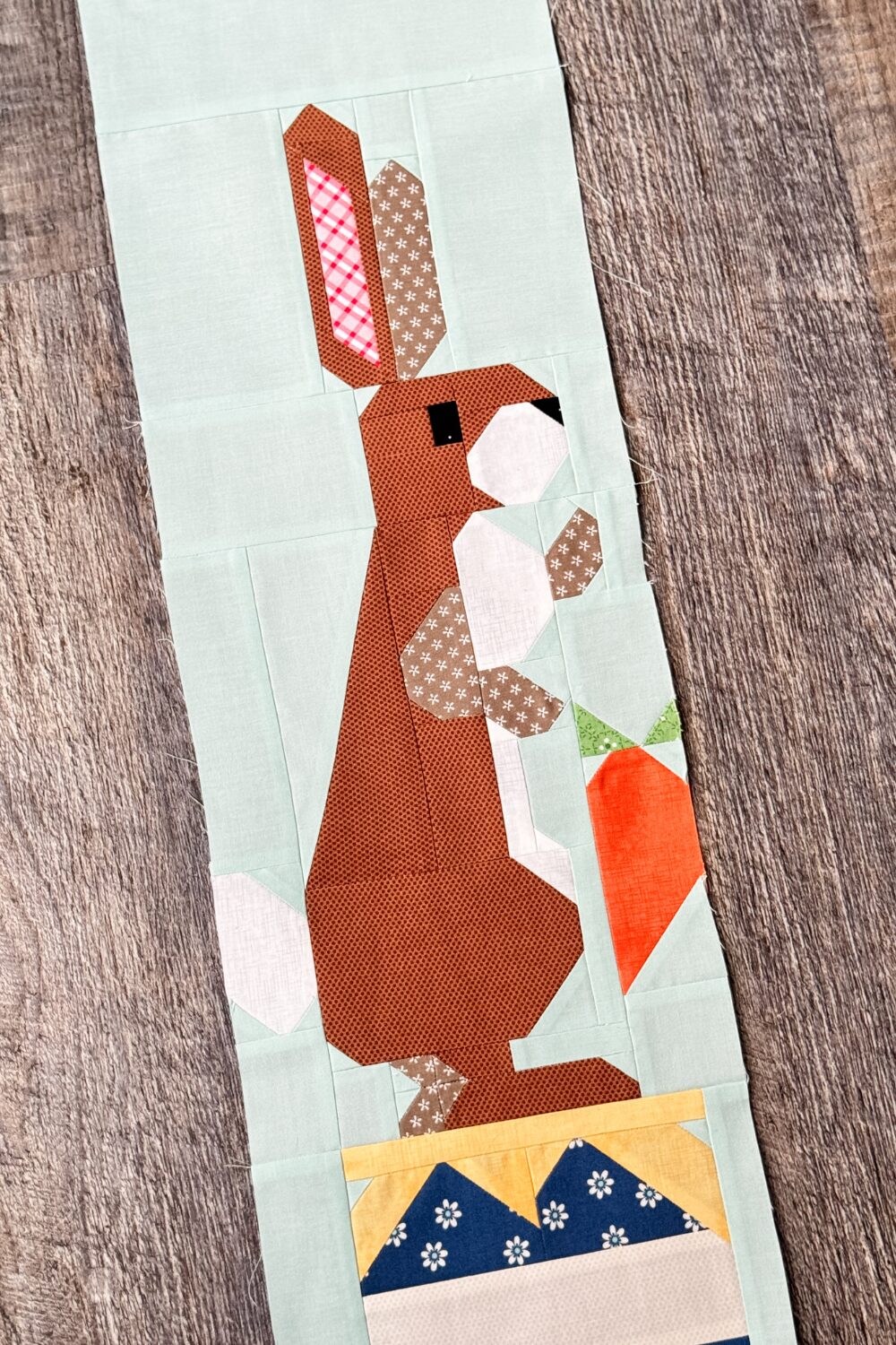 Close-up of Rabbit quilt block highlighting Rabbit’s face and the carrot in his hand.