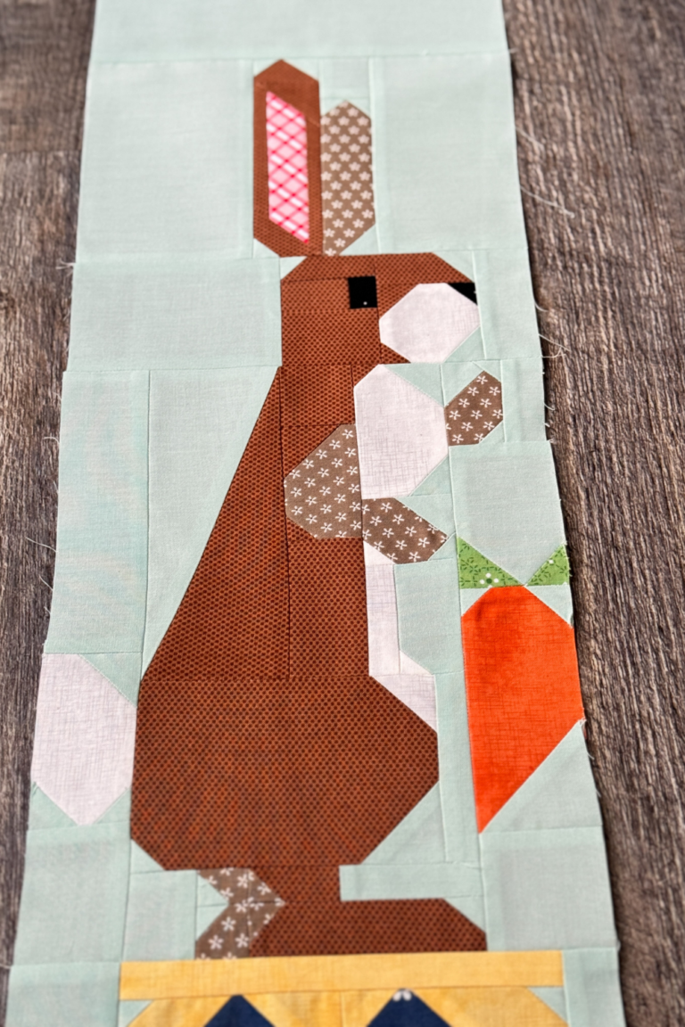 Close-up of Rabbit quilt block highlighting Rabbit’s face and the carrot in his hand.