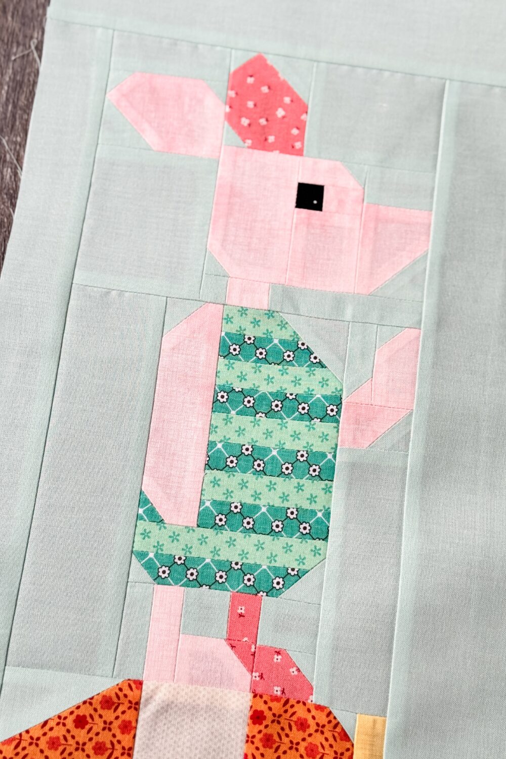 An angled close-up of the Piglet block, highlighting fabric details and Piglet's shirt.