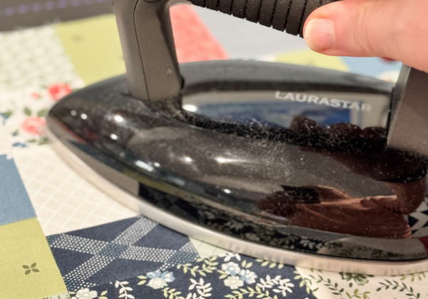 Close-up of pressed quilt seams with fabric pieces neatly aligned for accurate piecing.