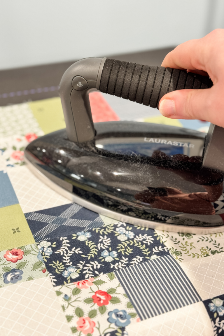 Close-up of pressed quilt seams with fabric pieces neatly aligned for accurate piecing.
