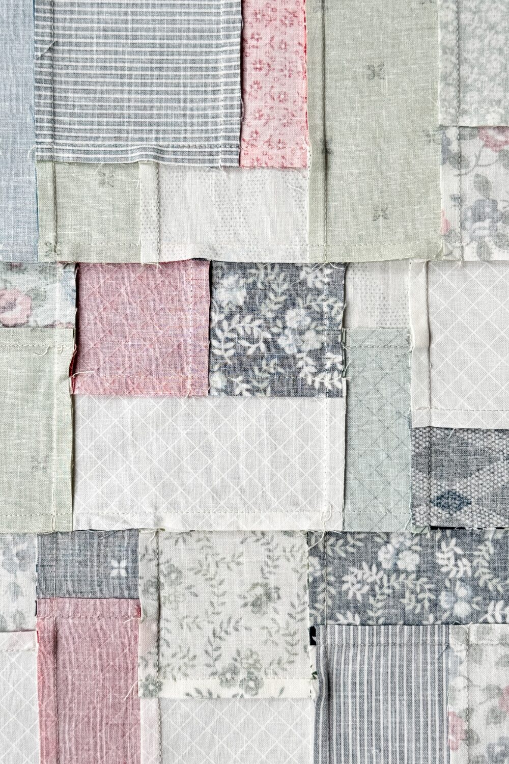 Back of a quilt block with neatly pressed seams, reducing bulk and improving quilt accuracy.