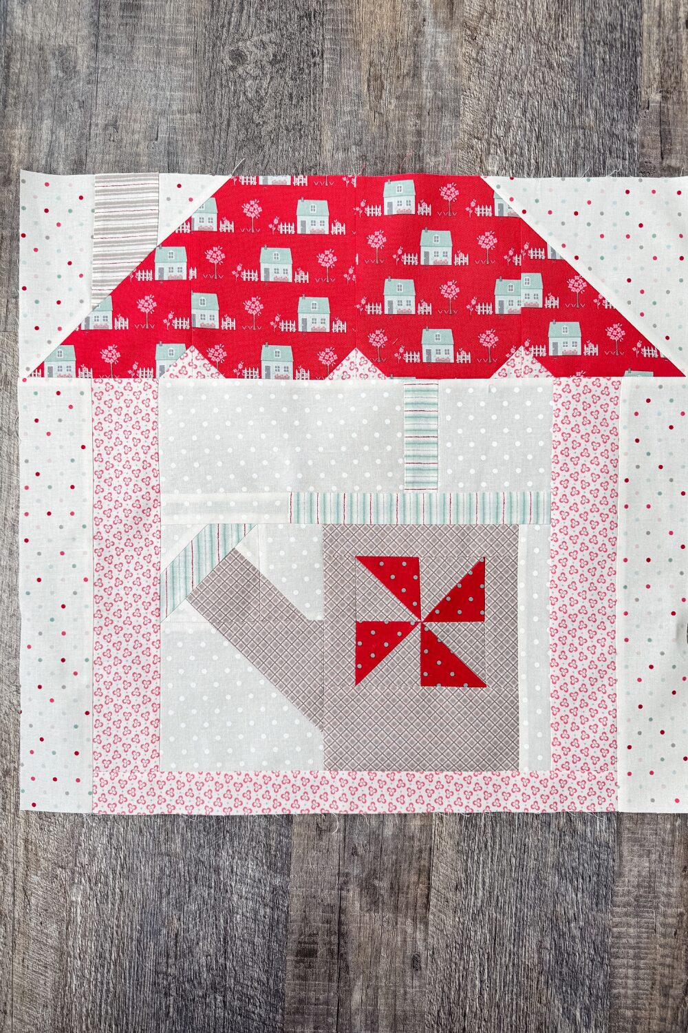 Garden & Grace quilt block in house setting as part of row assembly for quilt top.