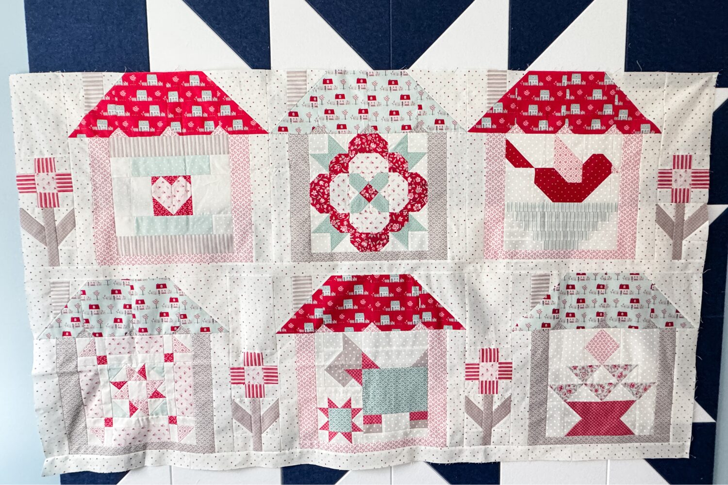 The top two rows of the Designer Mystery 2023 quilt along quilt featuring fabrics from My Summer House collection by Bunny Hill Designs.