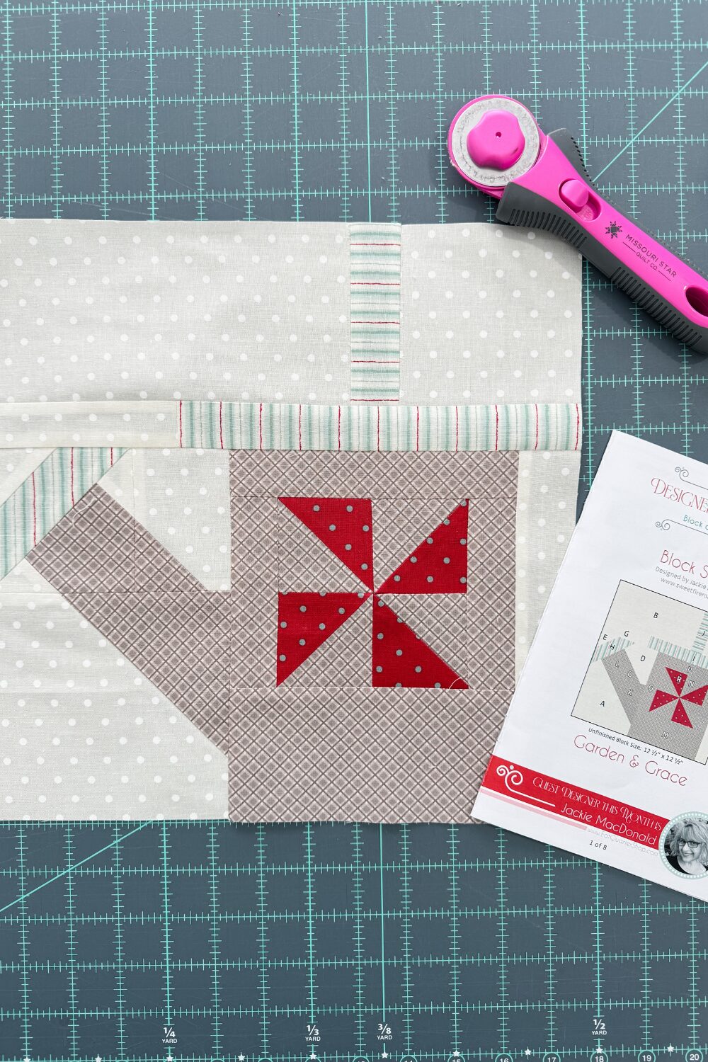 Finished 12" Garden & Grace quilt block showing watering can and pinwheel detail.