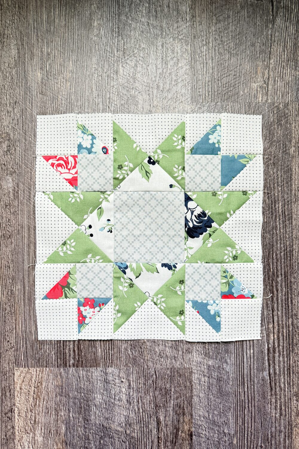 12-inch Union Square quilt block with a star pattern made from HSTs, hourglass units, and squares.
