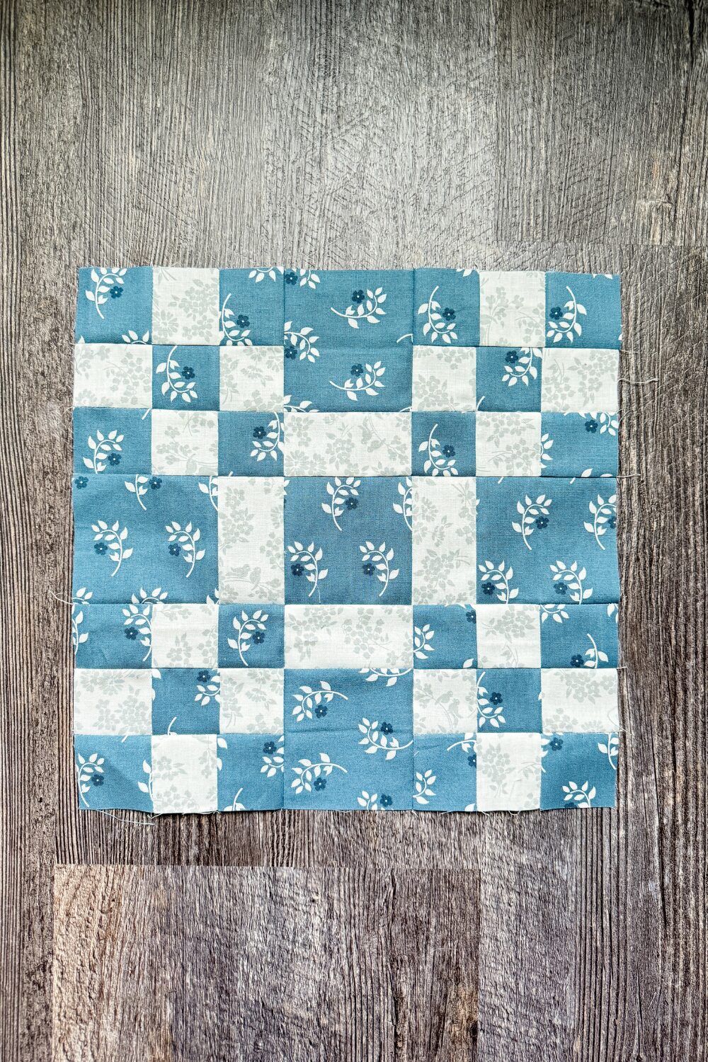 12-inch Building Blocks quilt block with nine-patch corners and a solid center square.