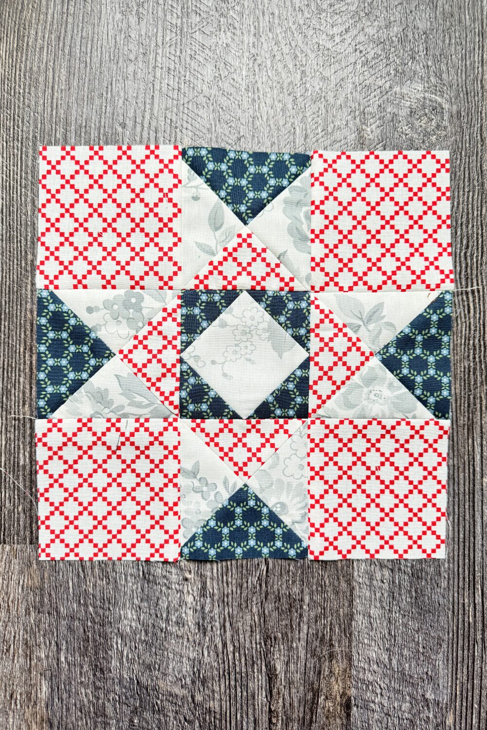 9-inch Album Star quilt block with hourglass units and a fussy cut center.
