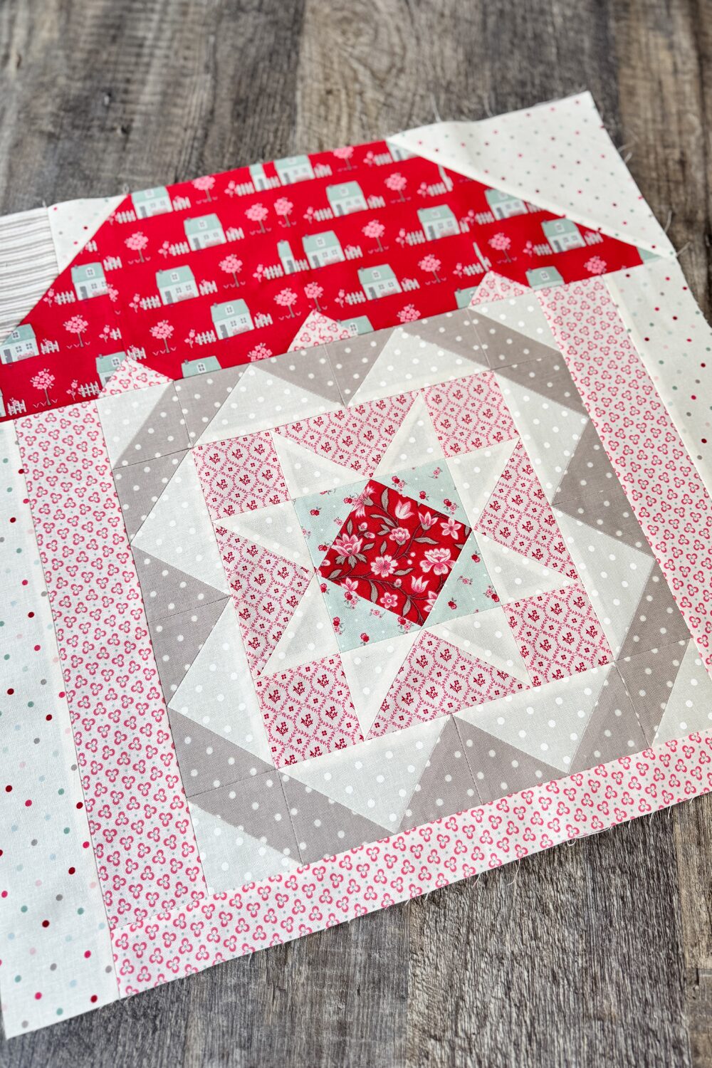 Safe Haven quilt block in house setting as part of quilt row assembly.