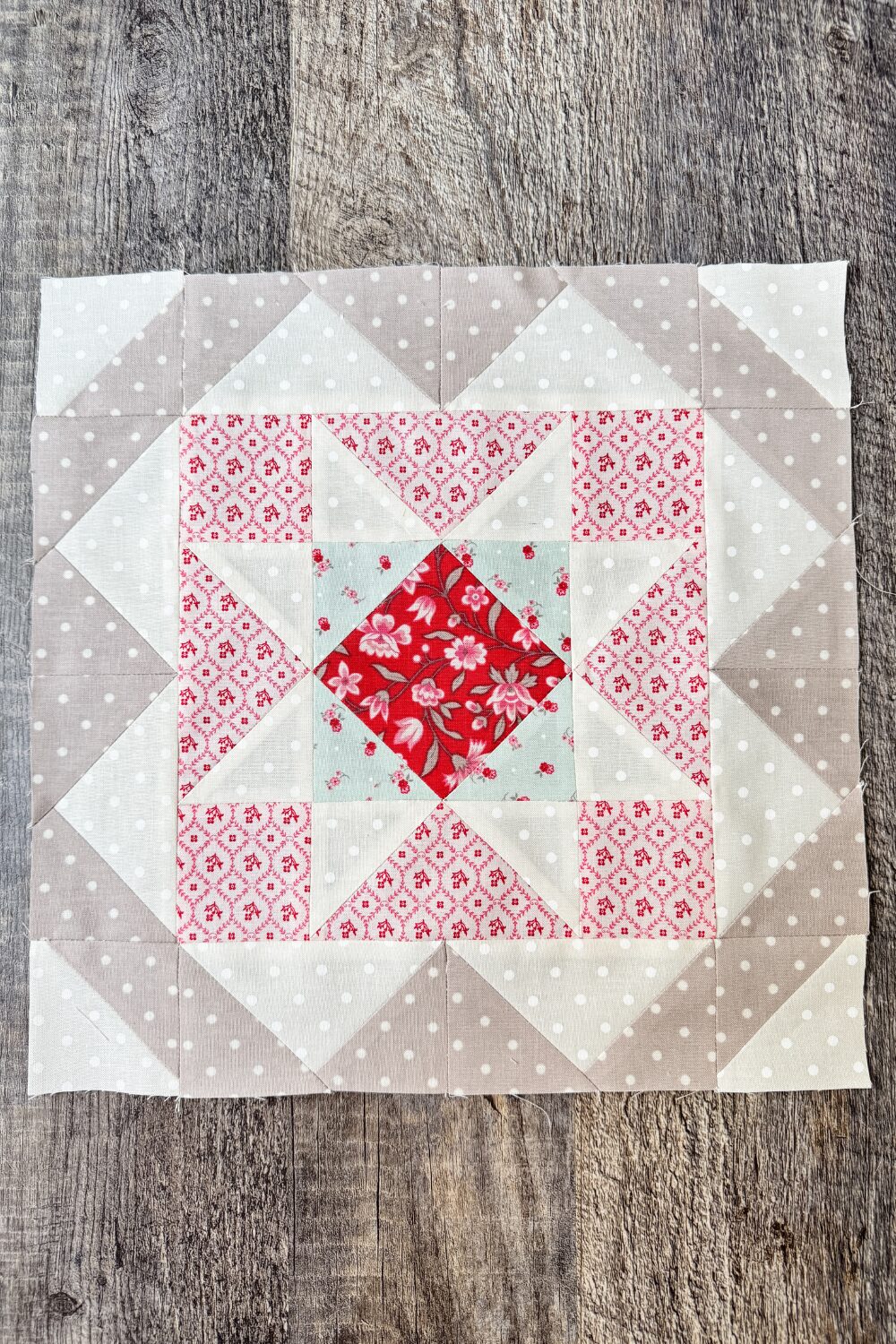 Finished 12" Safe Haven quilt block with star center, HSTs, and flying geese.