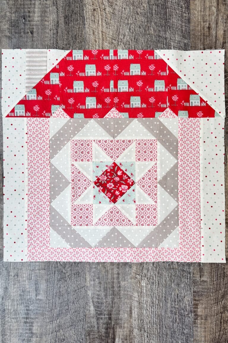Safe Haven quilt block in house setting as part of quilt row assembly.