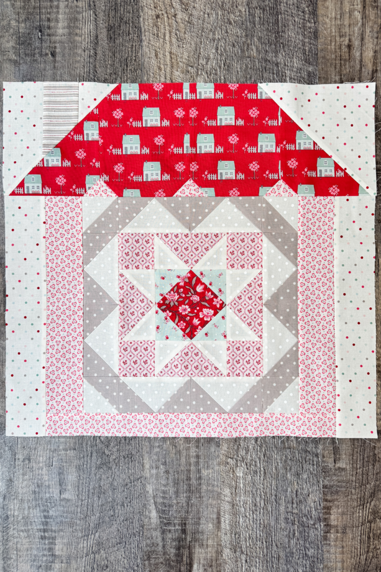 Safe Haven quilt block in house setting as part of quilt row assembly.