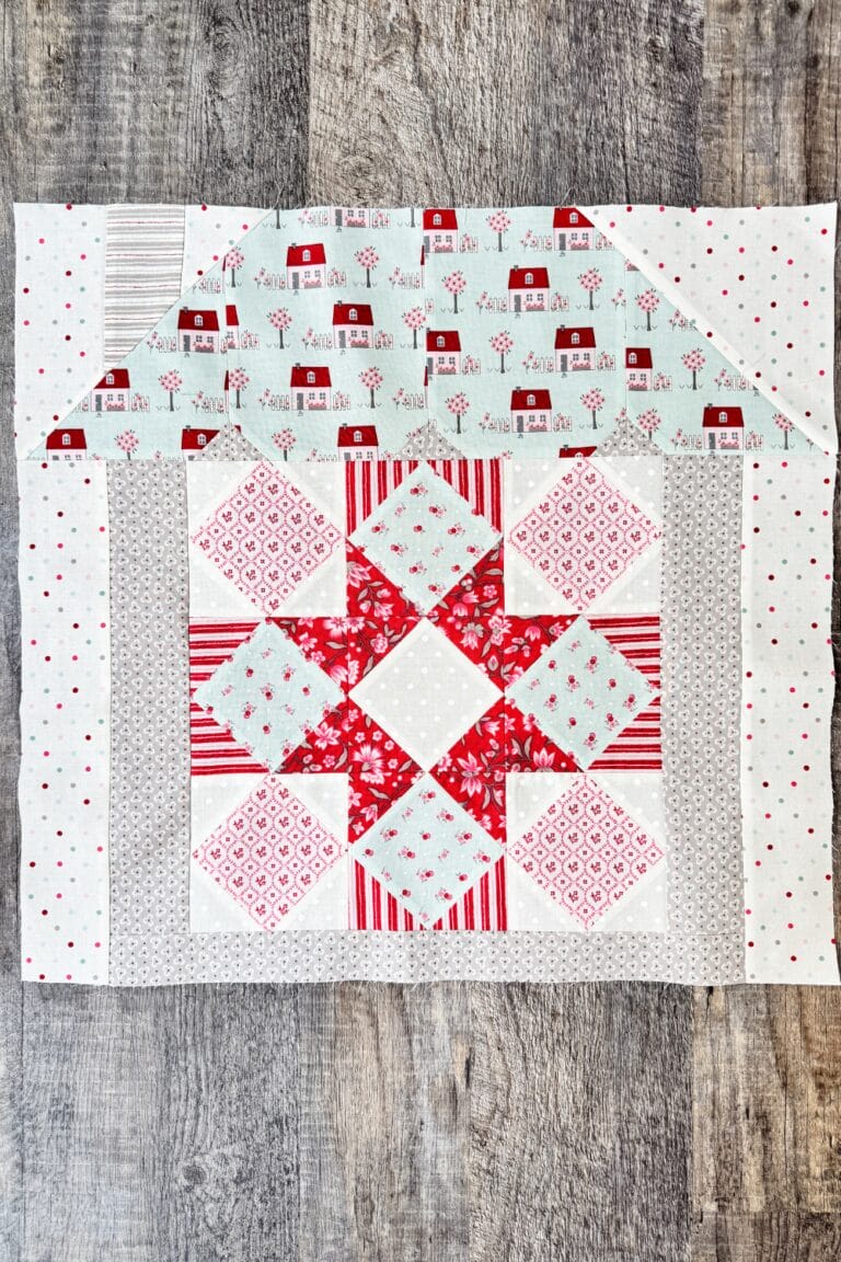 Hugs & Kisses quilt block in house setting ready to be added to the assembled quilt top.