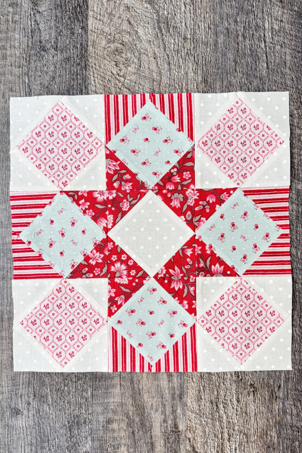 Finished 12" Hugs & Kisses quilt block with star effect from fabric placement.