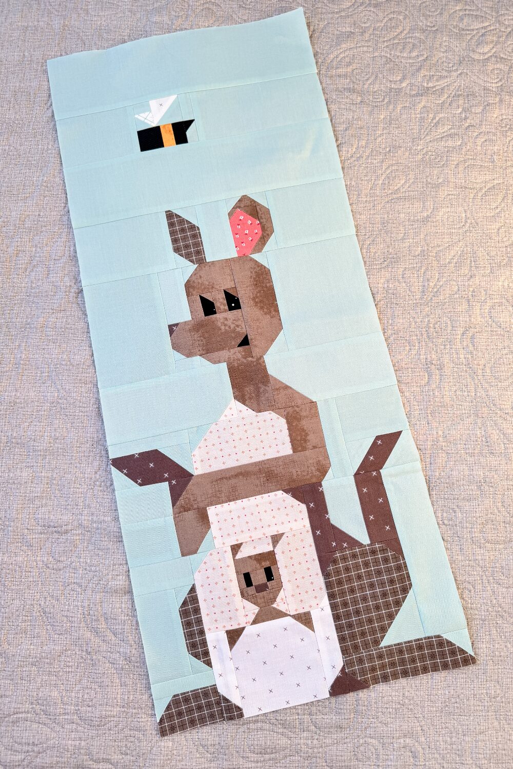 Finished Kanga and Roo quilt block showing Roo in Kanga’s pouch.
