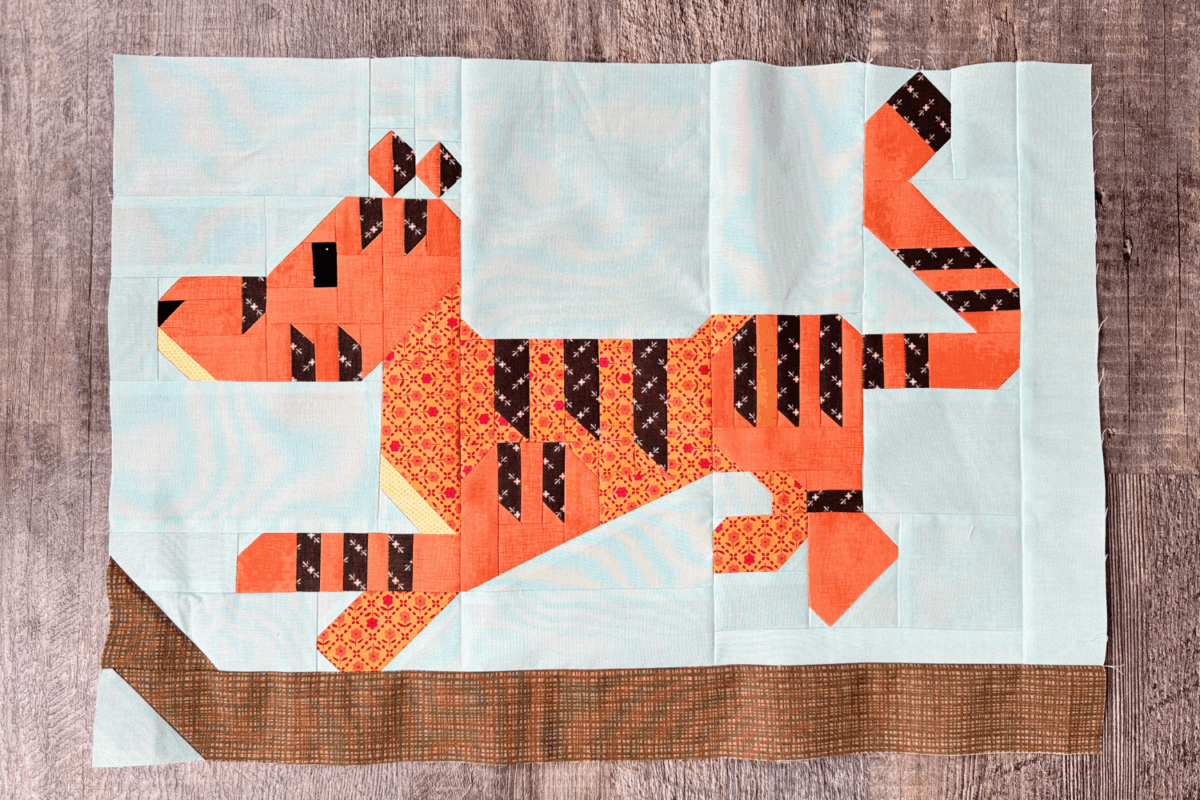Finished Tigger quilt block from the 100 Acre Wood quilt along, with Tigger walking along a branch.