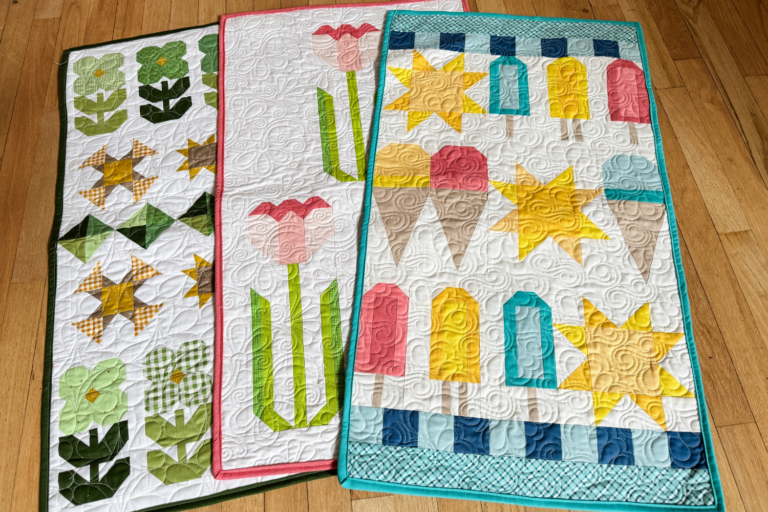 March, May, and June quilted door banner kits fully finished with seasonal designs and hanging sleeves.
