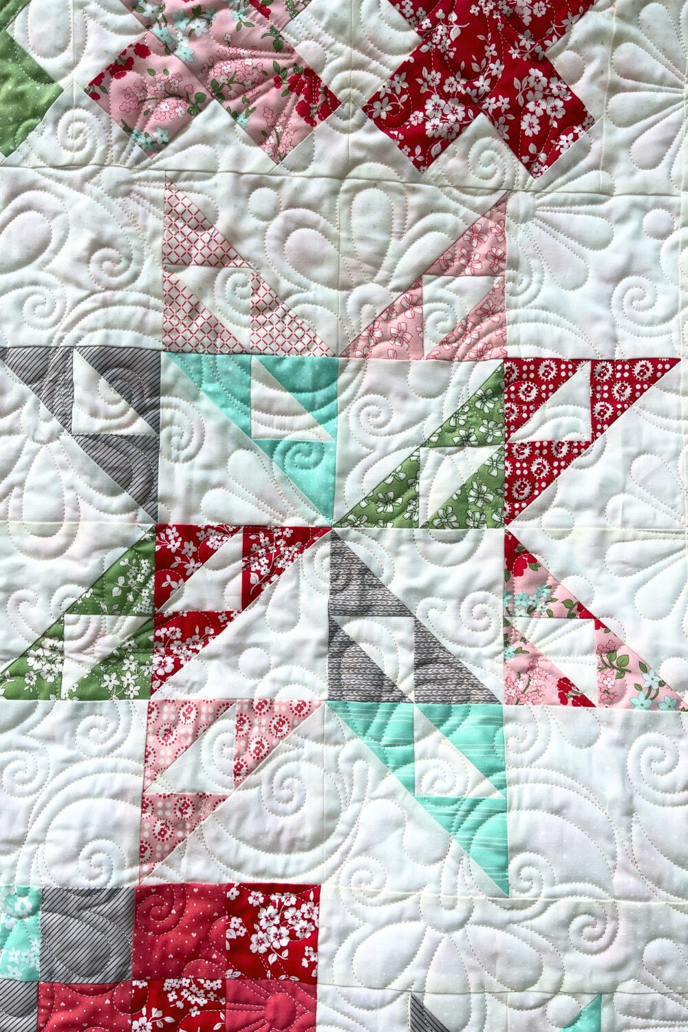 Star block from Shine Bright quilt with detailed Flowers Rise Again quilting design.