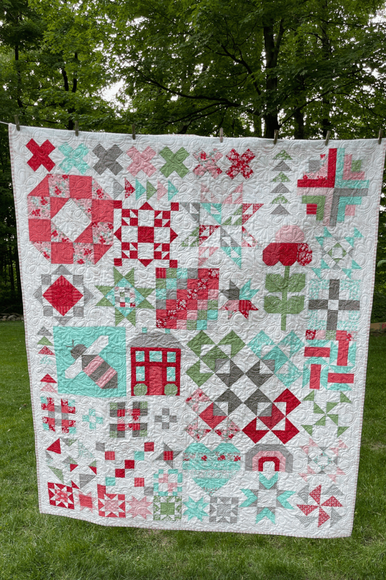 Completed Shine Bright quilt made with Lighthearted fabrics, hanging outdoors on a clothesline.