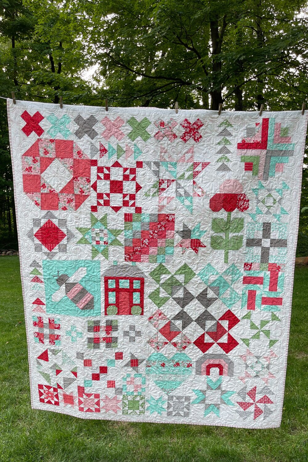 Completed Shine Bright quilt made with Lighthearted fabrics, hanging outdoors on a clothesline.