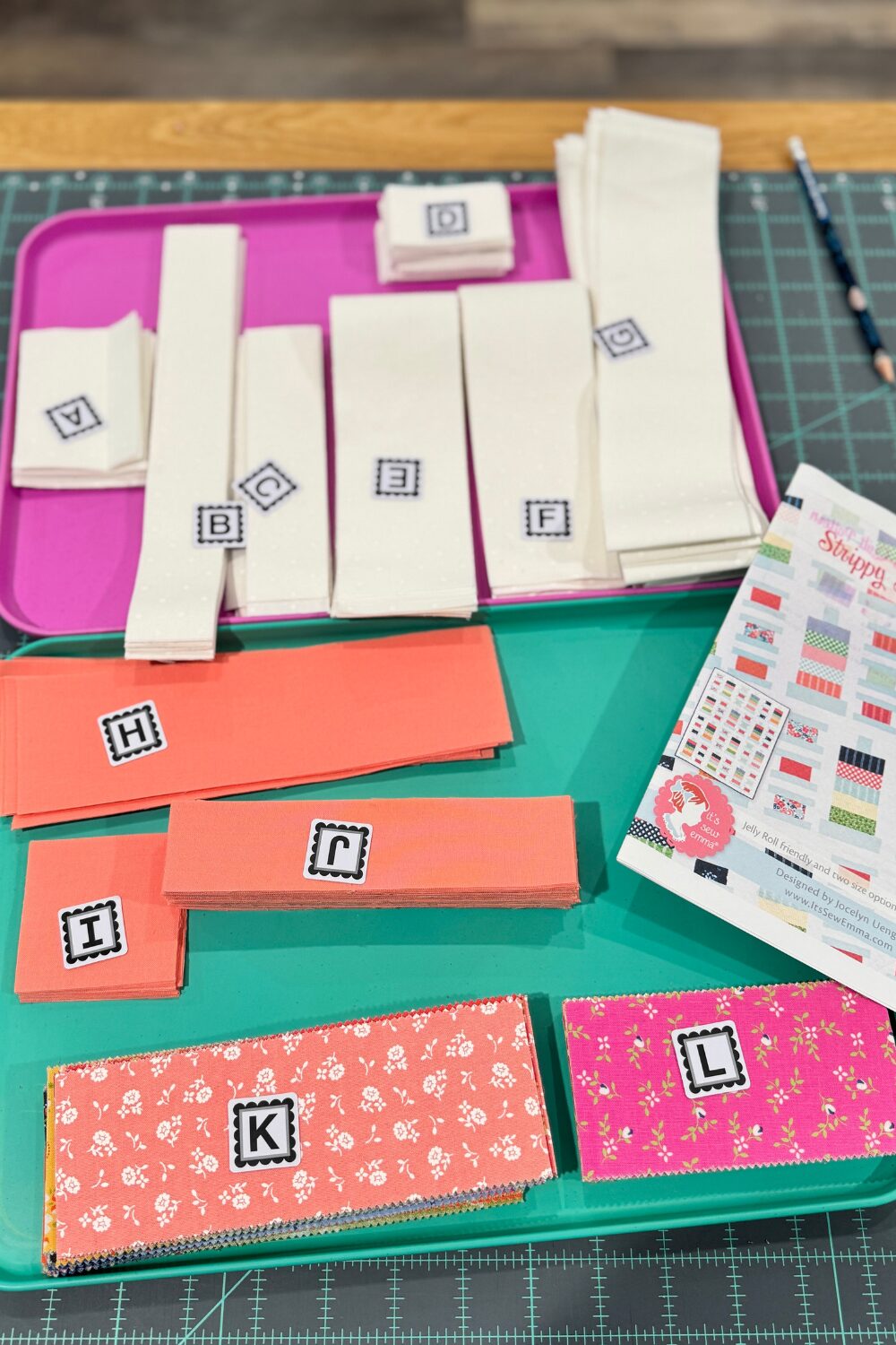 Stacks of fabric pieces cut and ready for sewing the Strippy Spools quilt blocks.