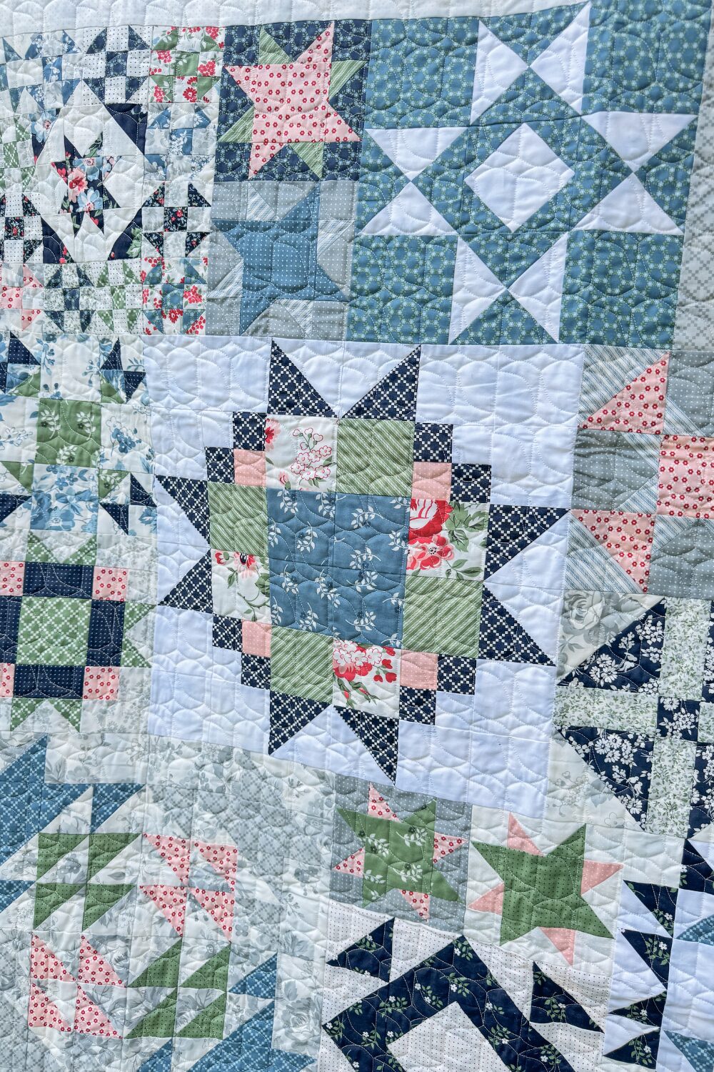 Close-up view of quilting texture showing the Refract pantograph on the Piece and Quilt Sampler quilt.