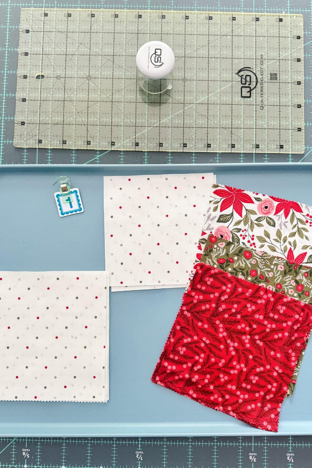 Fabric pull for block 1 of the Jolly Bar 5 Quilt Along. Background Magic Dot Christmas, a red, green, and colorful low volume on white background.