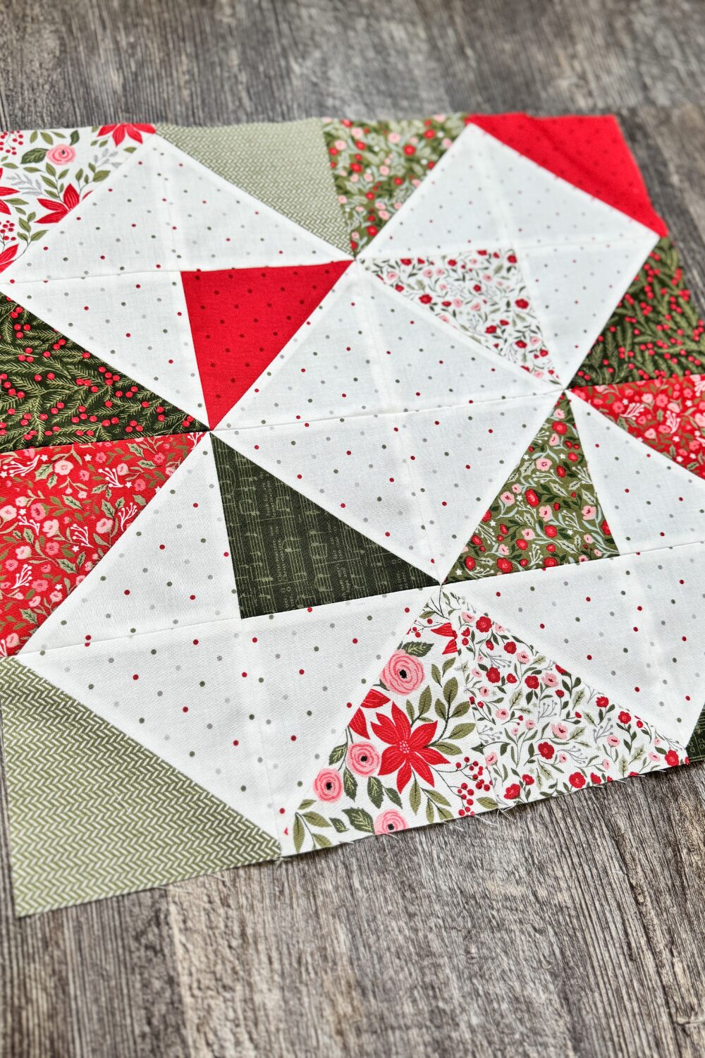 Angled photo of the completed Refractions block. Quilt block 4 in the Jolly Bar 5 quilt along