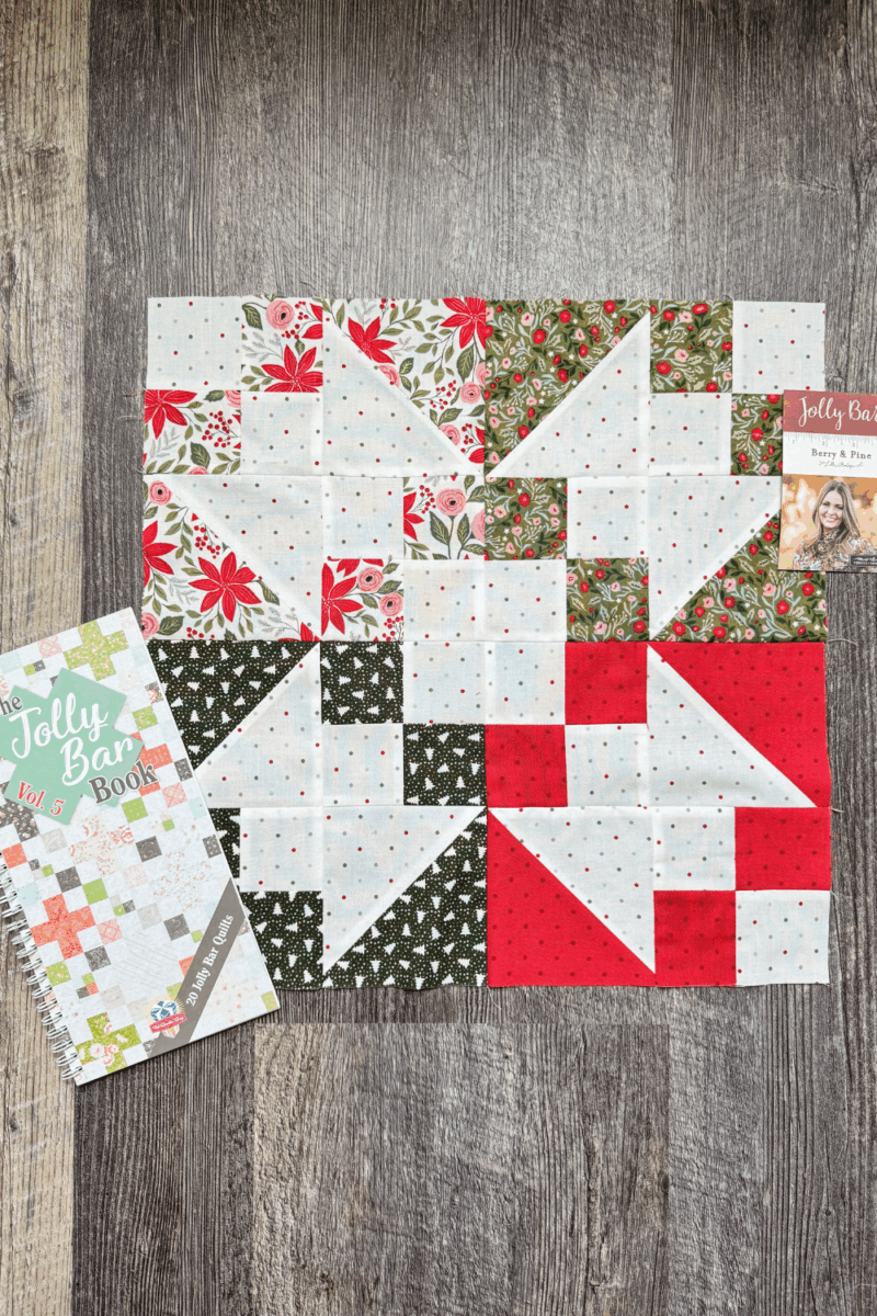 Flat lay of the Jolly Bar Book Vol. 5 with Berry & Pine Jolly Bars used for the Variations block in the Jolly Bar 5 Quilt Along.