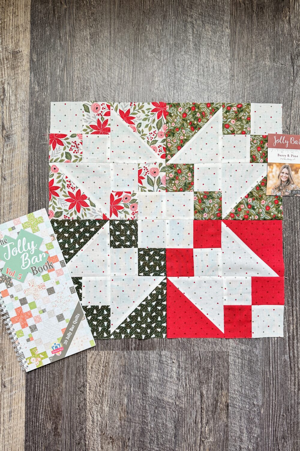 Flat lay of the Jolly Bar Book Vol. 5 with Berry & Pine Jolly Bars used for the Variations block in the Jolly Bar 5 Quilt Along.