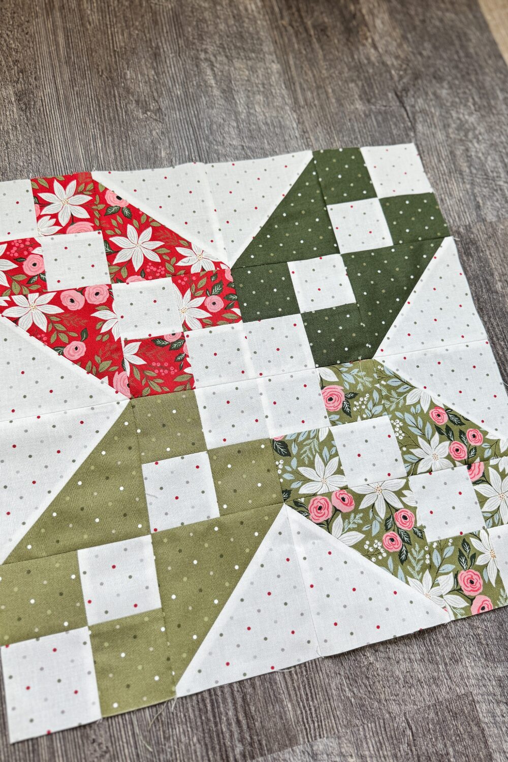 Angled overhead view of the XOXO quilt block showing fabric details and piecing in the Jolly Bar 5 Quilt Along.